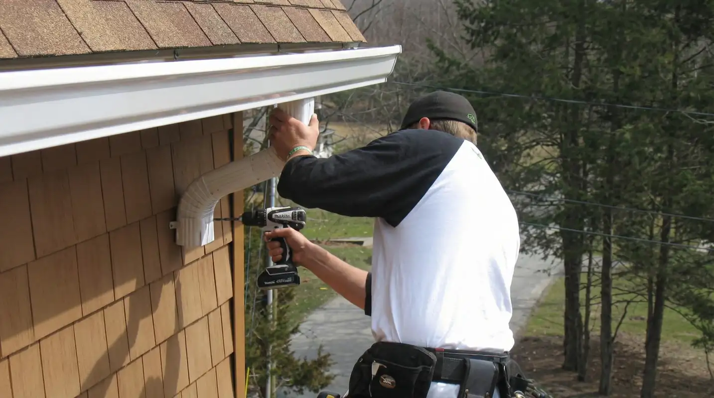 Professional contractor installing tan vinyl siding panels on a residential home exterior in Mesa, AZ