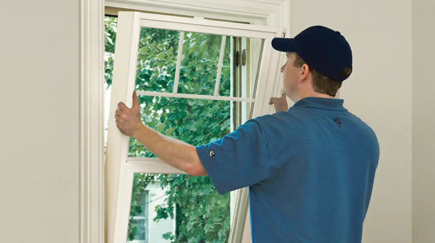 Professional contractors performing a residential window insulation and replacement service in Mesa, AZ